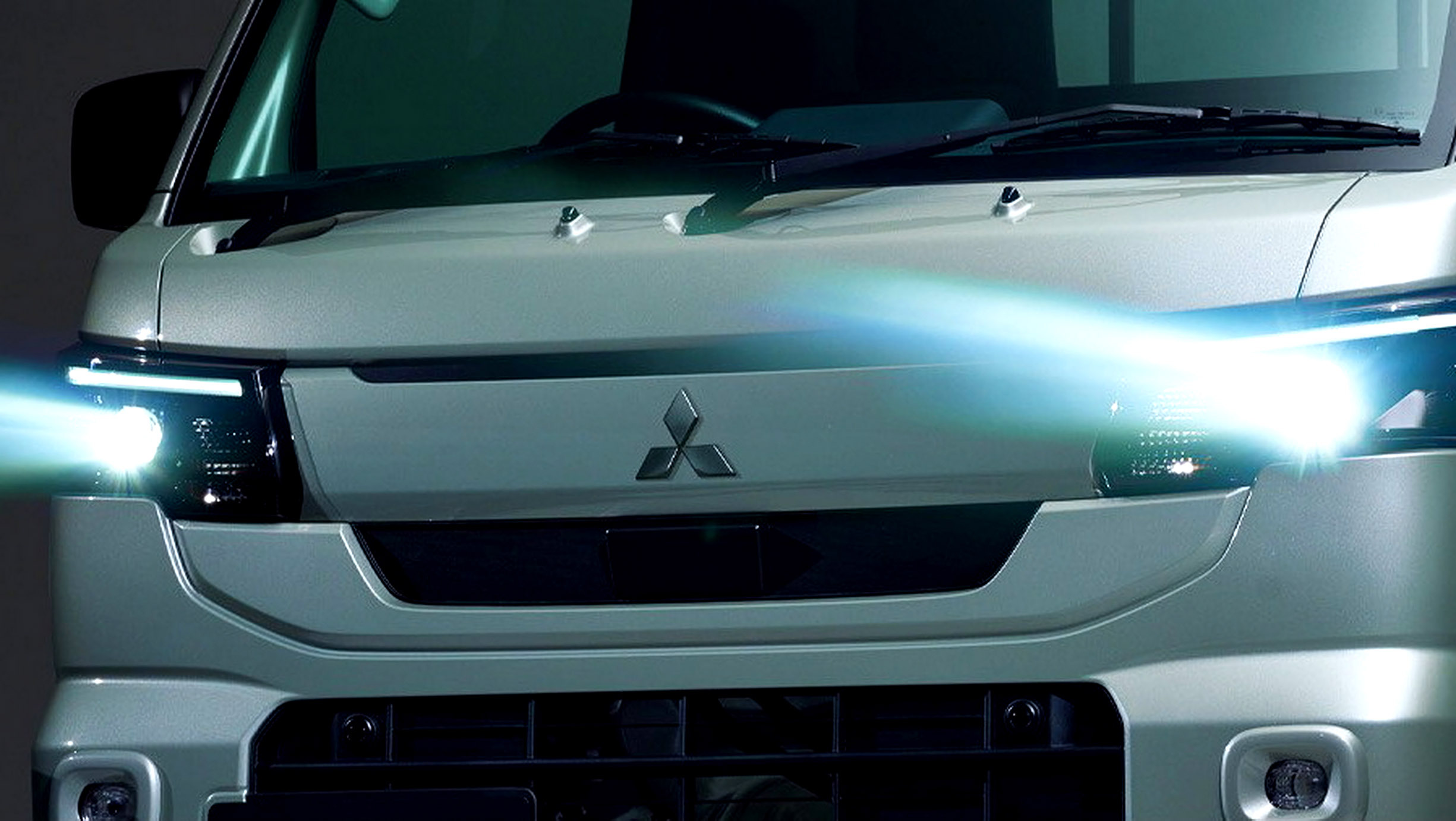 2026 Mitsubishi Minicab Truck in olive green, the facelifted G trim with LED headlights and chrome door handles