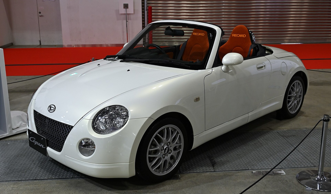 Silver first generation Daihatsu Copen L880K roadster with round headlights