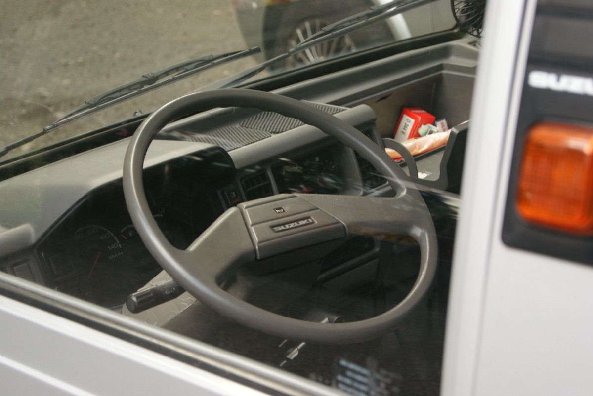 Interior view of a kei truck cab showing compact dashboard layout